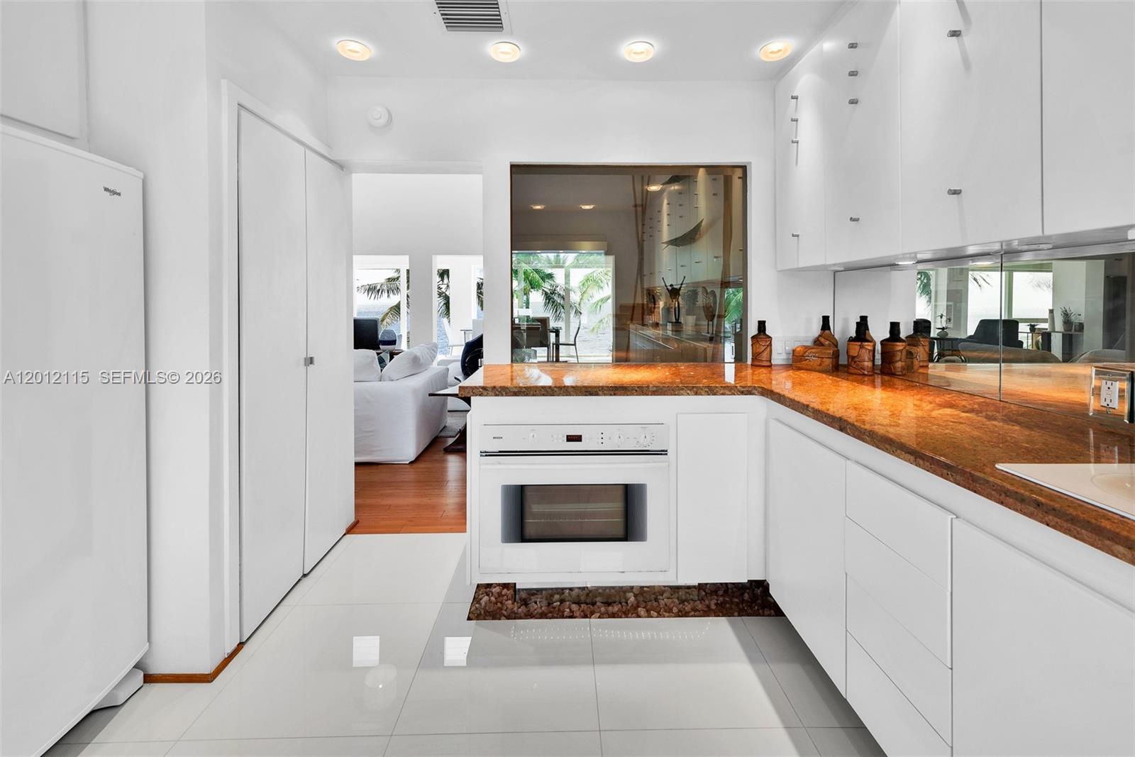 60 Ocean Front Drive Key Largo, FL 33037 - Photo 59 of 85 a kitchen with stainless steel appliances granite countertop a stove a sink and a microwave