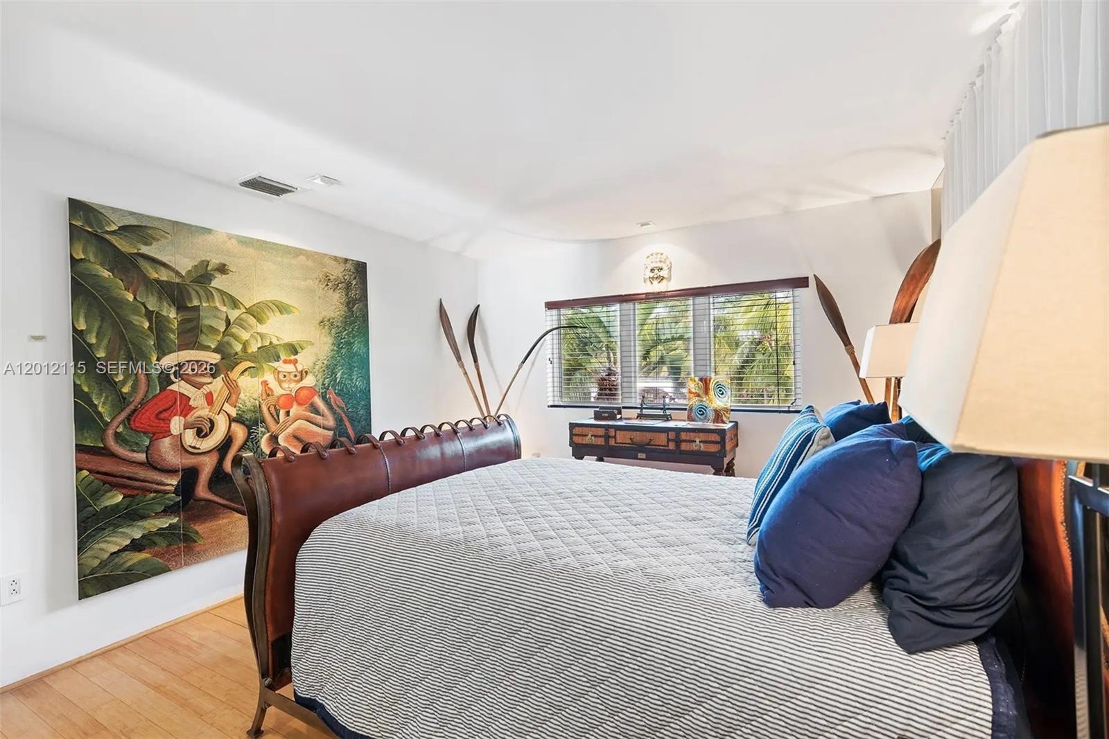 60 Ocean Front Drive Key Largo, FL 33037 - Photo 67 of 85 a bedroom with a bed and a painting on the wall