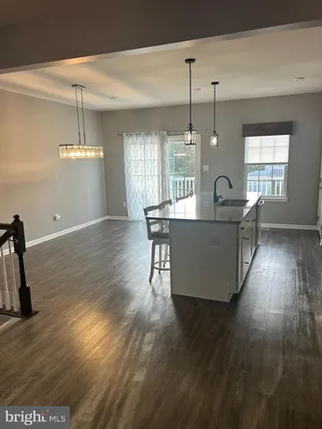 a kitchen with appliances a sink and cabinets