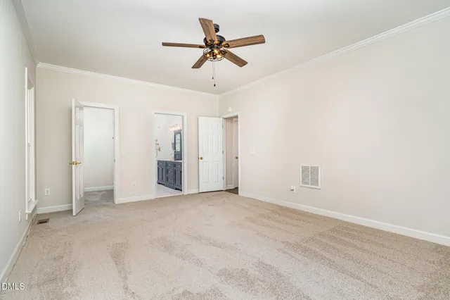 an empty room with window and a ceiling fan