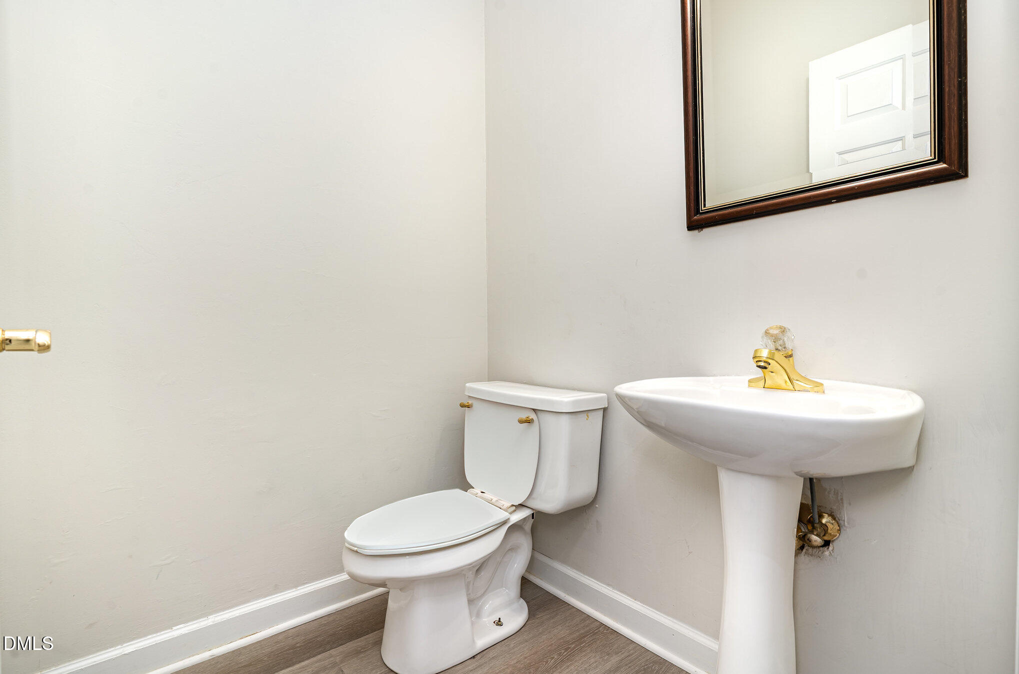 2425 Welsh Tavern Way Wake Forest, NC 27587 - Photo 19 of 34 a bathroom with a toilet sink and mirror