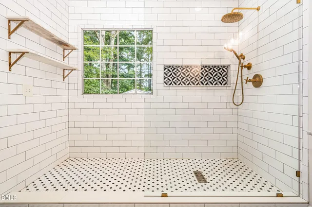 a bathroom with a sink a mirror and shower