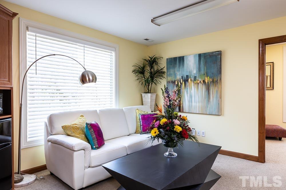 11437 John Allen Road Raleigh, NC 27614 - Photo 30 of 50 a living room with furniture and a potted plant