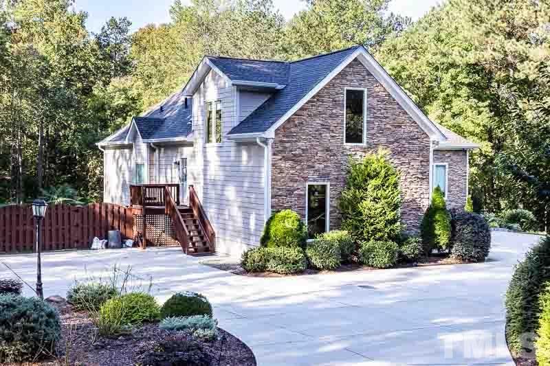 11437 John Allen Road Raleigh, NC 27614 - Photo 6 of 50 a view of a brick house with a small yard plants and large trees