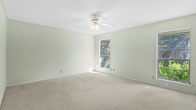 an empty room with windows and closet
