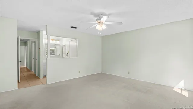 a view of a chandelier fan and entryway