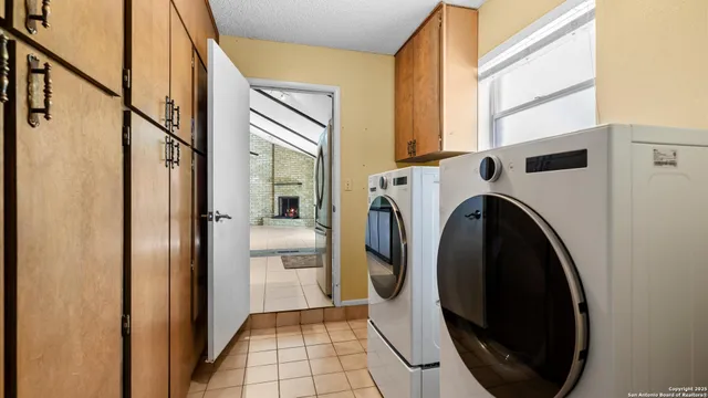 a view of a hallway with washer and dryer
