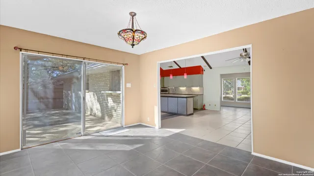 a view of a room with window and chandelier