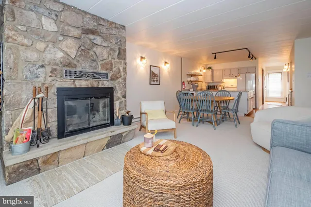 a living room with furniture a fireplace and a table