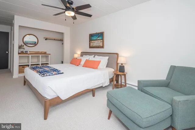 a bedroom with a bed and ceiling fan