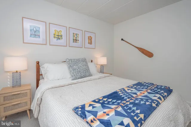 a bedroom with bed and cupboard