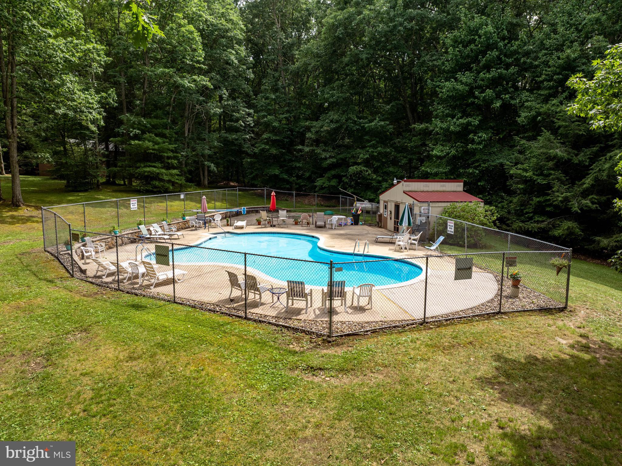 189 Red Run Road, Unit 1C2 Oakland, MD 21550 - Photo 38 of 50 a swimming pool with outdoor seating and yard