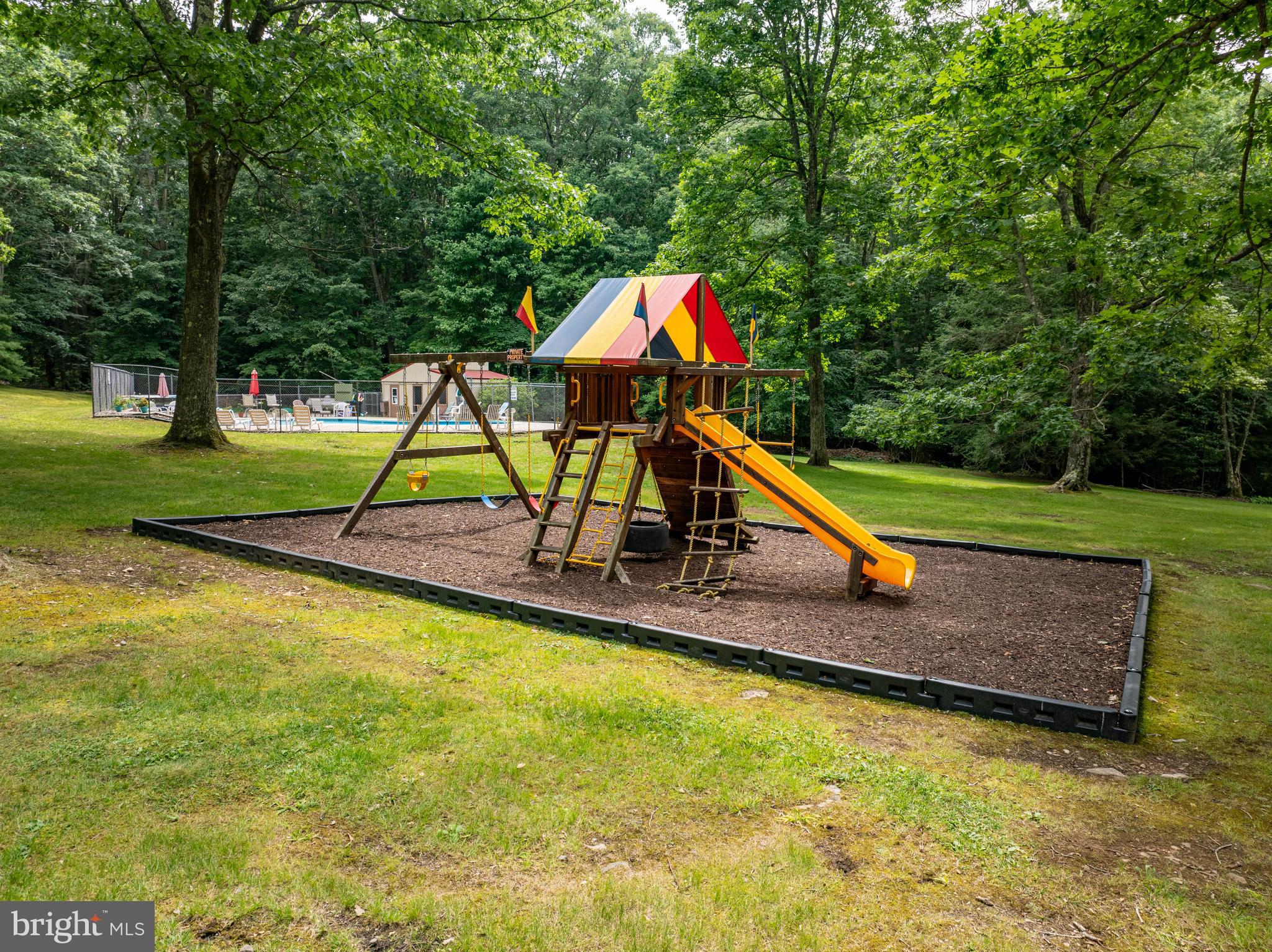 189 Red Run Road, Unit 1C2 Oakland, MD 21550 - Photo 39 of 50 a park with a slide and large trees