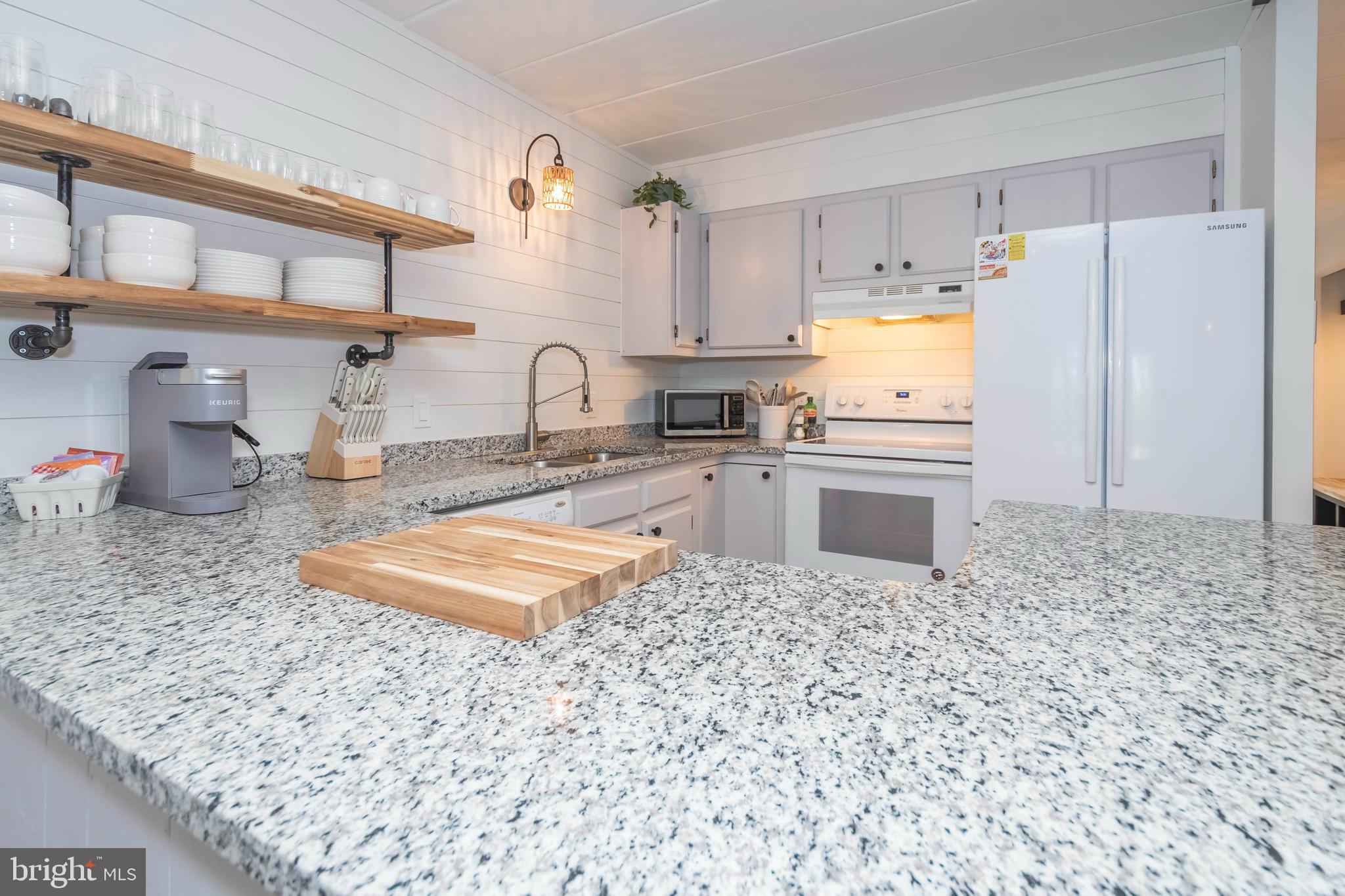 189 Red Run Road, Unit 1C2 Oakland, MD 21550 - Photo 4 of 50 a kitchen with stainless steel appliances granite countertop a sink a stove a refrigerator a washer and dryer