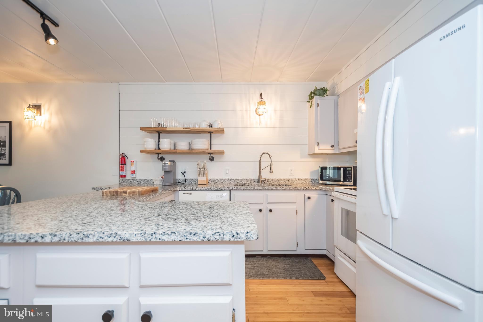 189 Red Run Road, Unit 1C2 Oakland, MD 21550 - Photo 5 of 50 a kitchen with stainless steel appliances granite countertop a sink stove and cabinets