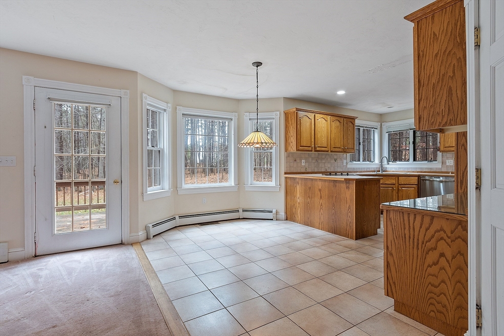 96 Cedarwood Road Boxborough, MA 01719 - Photo 16 of 41 a kitchen with stainless steel appliances granite countertop a refrigerator and microwave