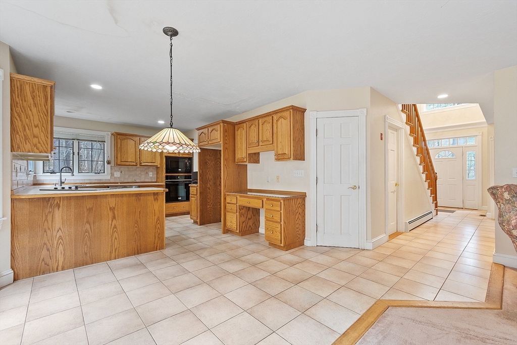 96 Cedarwood Road Boxborough, MA 01719 - Photo 17 of 41 a kitchen with stainless steel appliances kitchen island granite countertop a refrigerator a sink and a stove