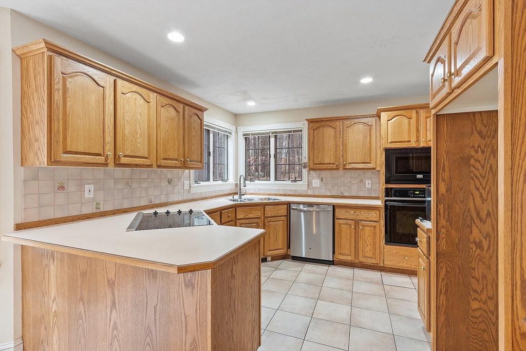 96 Cedarwood Road Boxborough, MA 01719 - Photo 18 of 41 a kitchen with granite countertop a sink stainless steel appliances and cabinets