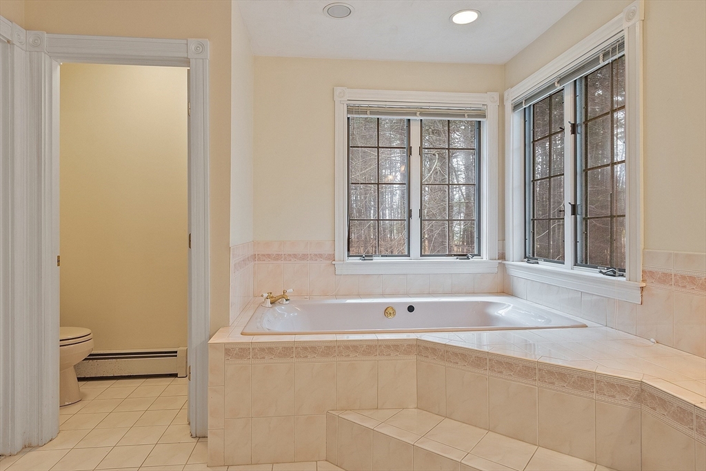 96 Cedarwood Road Boxborough, MA 01719 - Photo 24 of 41 a bathroom with bathtub and window