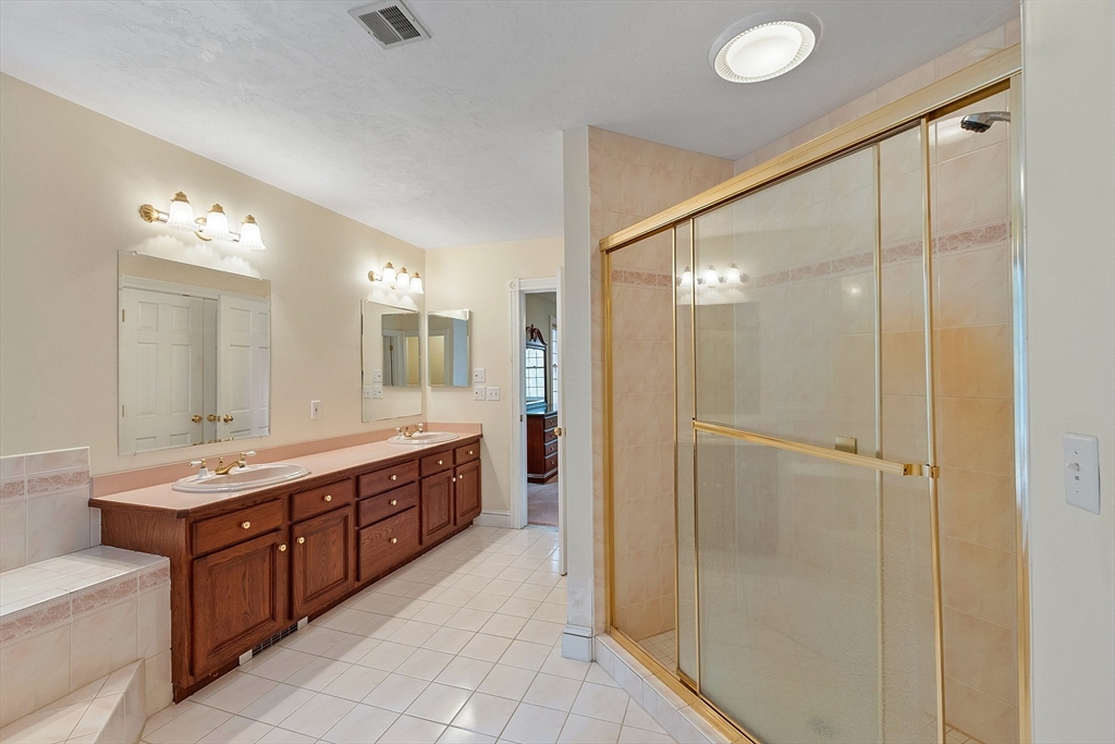 96 Cedarwood Road Boxborough, MA 01719 - Photo 25 of 41 a bathroom with a double vanity sink a large mirror and shower