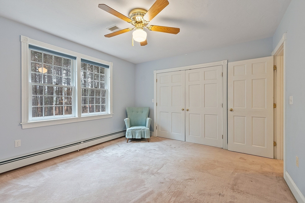 96 Cedarwood Road Boxborough, MA 01719 - Photo 28 of 41 an empty room with chandelier fan and windows
