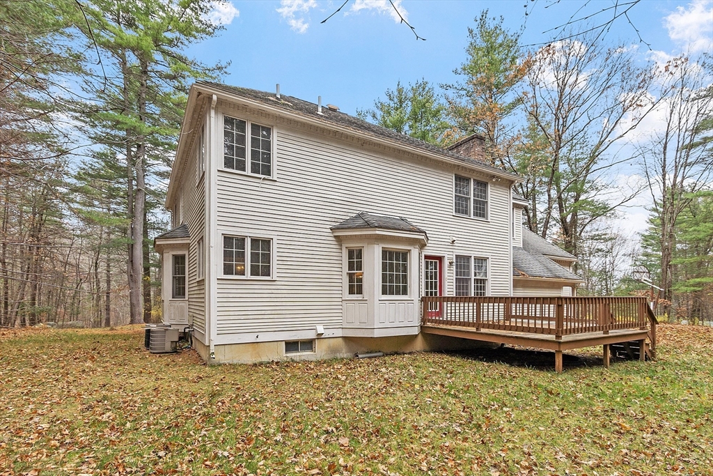 96 Cedarwood Road Boxborough, MA 01719 - Photo 38 of 41 a house with a garden and deck