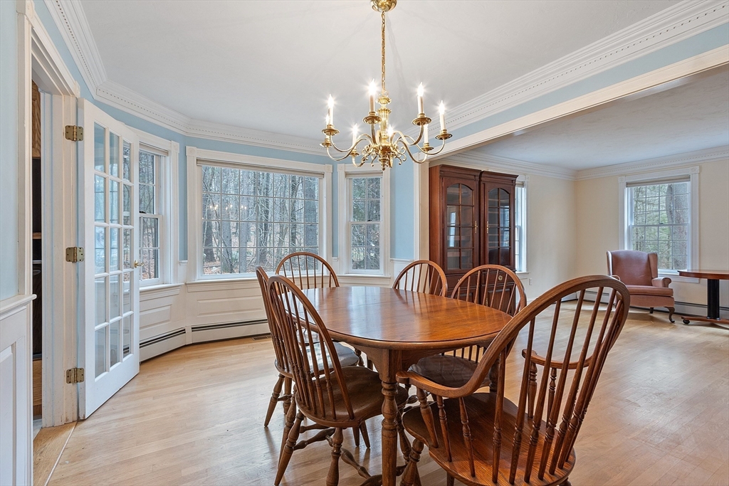 96 Cedarwood Road Boxborough, MA 01719 - Photo 8 of 41 a dining room with furniture a chandelier and wooden floor