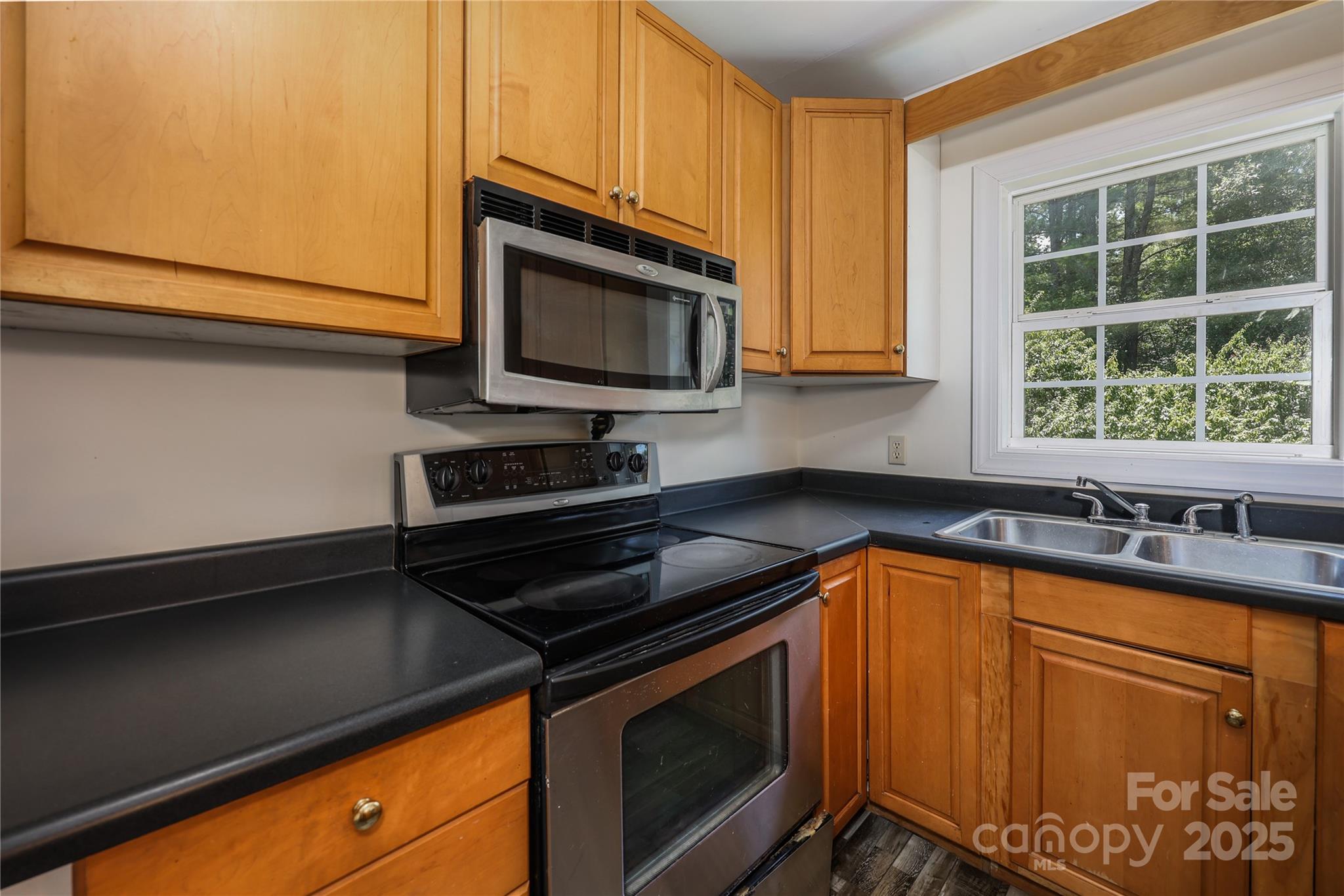 4651 Shiptontown Road, Unit 46 Denton, NC 27239 - Photo 18 of 48 a kitchen with granite countertop stainless steel appliances a stove microwave and sink