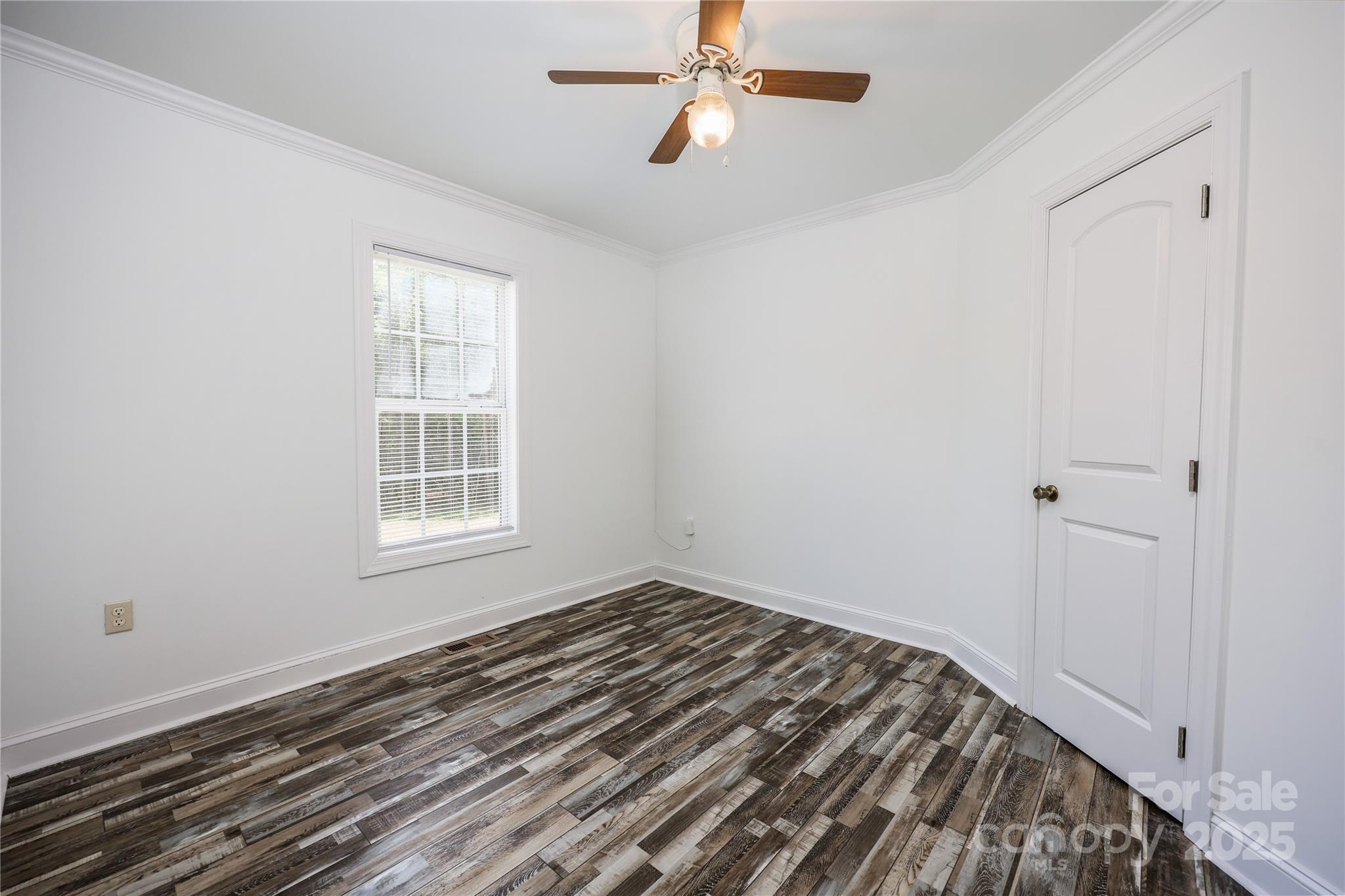 4651 Shiptontown Road, Unit 46 Denton, NC 27239 - Photo 25 of 48 a view of a bedroom with wooden floor and fan