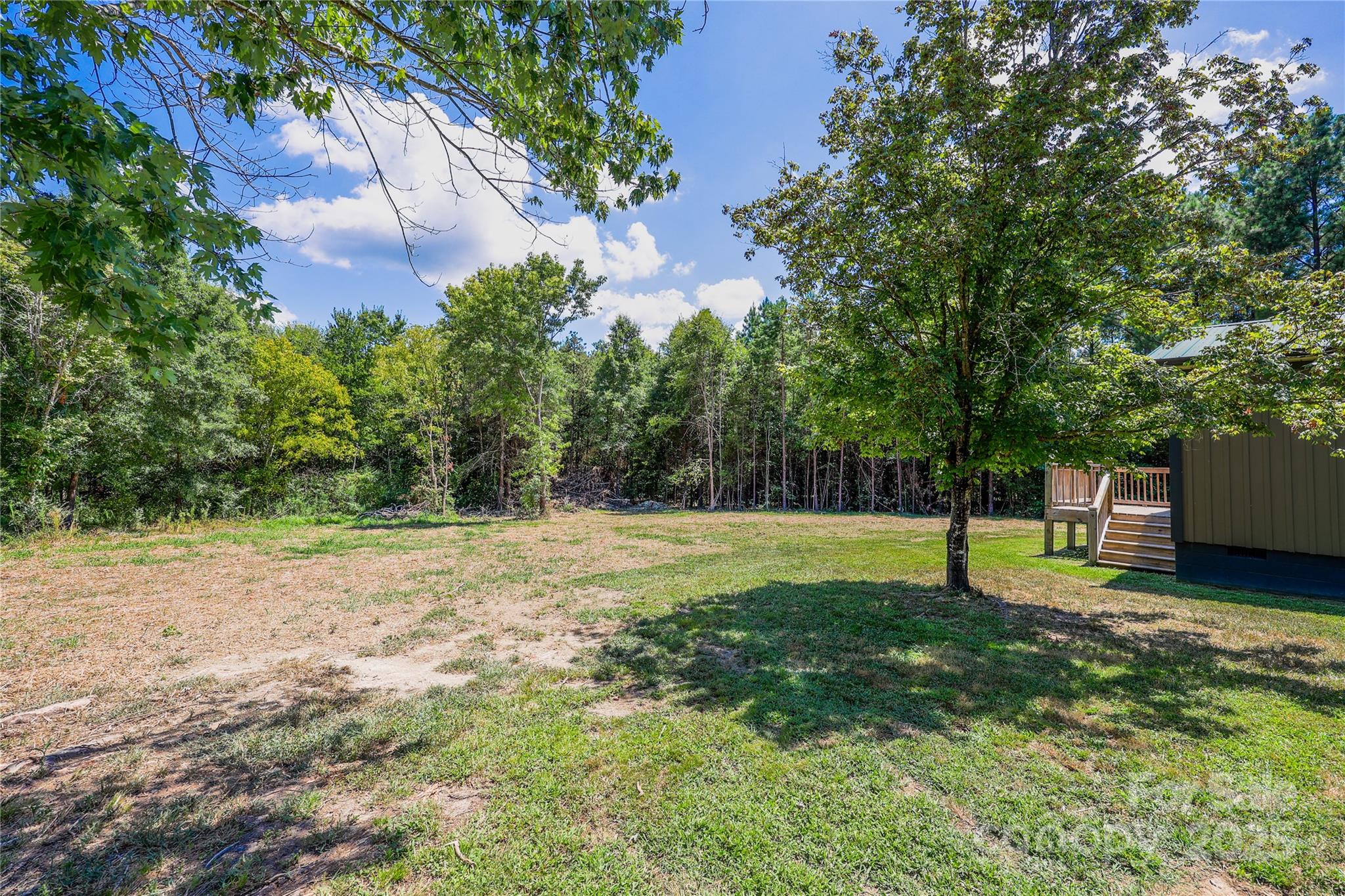 4651 Shiptontown Road, Unit 46 Denton, NC 27239 - Photo 31 of 48 a view of a yard with a tree