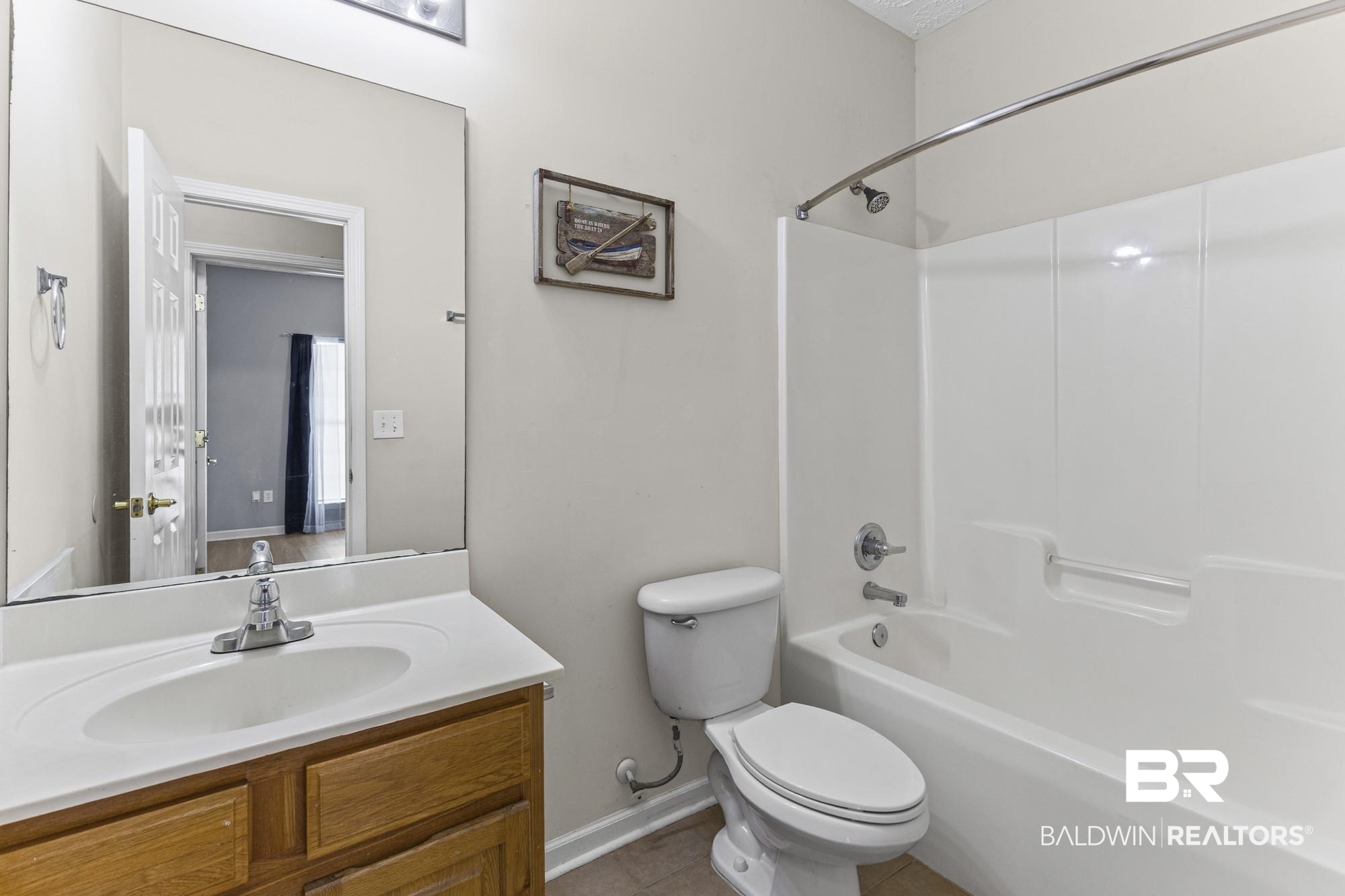 1153 Sloane Cove Foley, AL 36535 - Photo 21 of 25 Bathroom featuring vanity, tub / shower combination, and light tile patterned floors