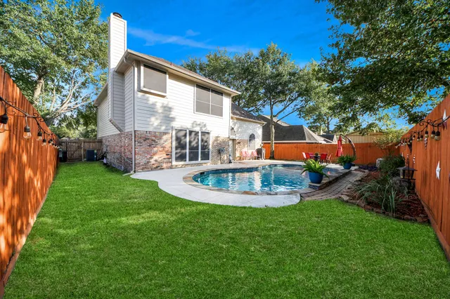 a view of a house with backyard and sitting area