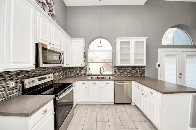 a kitchen with stainless steel appliances granite countertop a stove and a sink