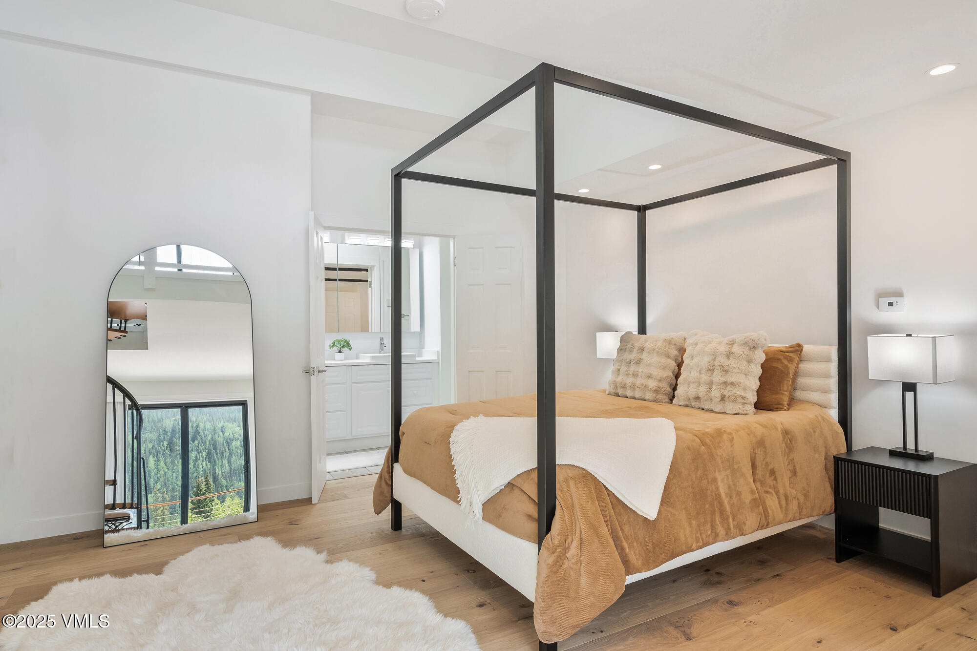 4545 Big Horn Road Vail, CO 81657 - Photo 23 of 49 a bedroom with a bed mirror and window