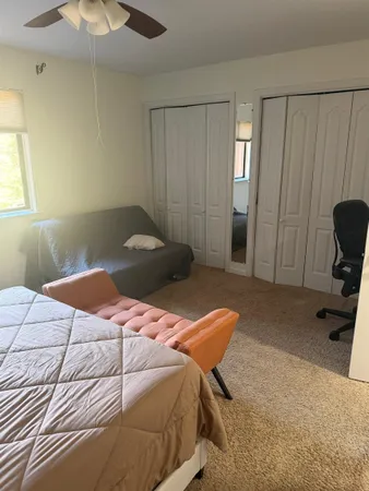 a bedroom with a bed and a chair