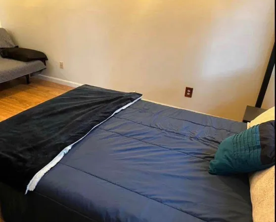 a bedroom with a bed and a potted plant