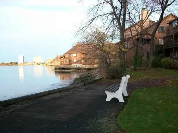a view of a lake with houses in the back