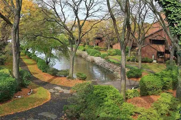 a view of swimming pool with outdoor seating and lake view