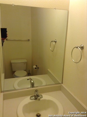 7231 Raintree Forest San Antonio, TX 78233 - Photo 11 of 20 a bathroom with a sink and a mirror