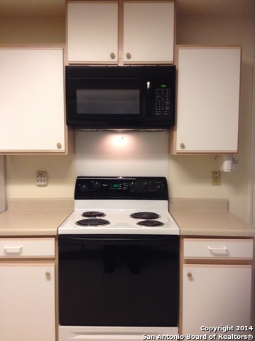 7231 Raintree Forest San Antonio, TX 78233 - Photo 6 of 20 a kitchen with a stove and a microwave