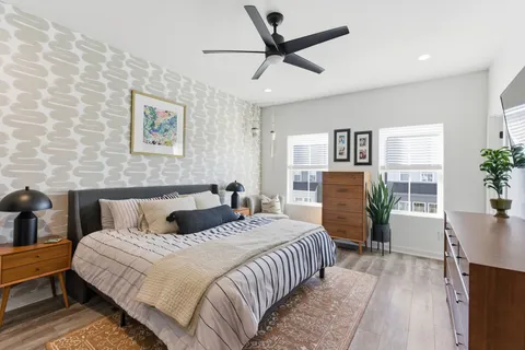 a bedroom with a large bed and a chandelier