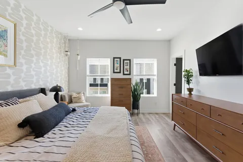 a bedroom with a bed and a flat screen tv