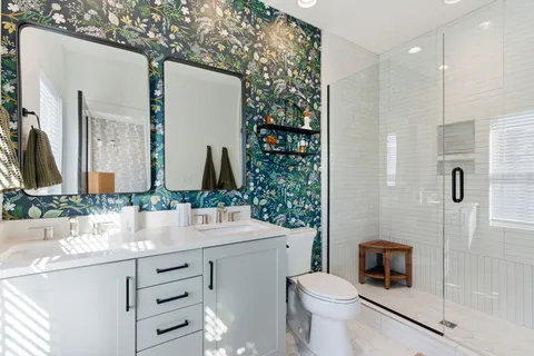 a bathroom with a sink vanity mirror and toilet