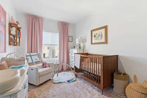 a bedroom with furniture and a large window