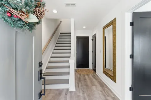 a view of entryway with stairs and wooden floor