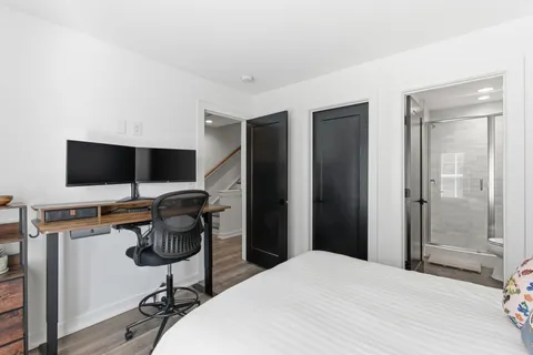 a bedroom with a workspace