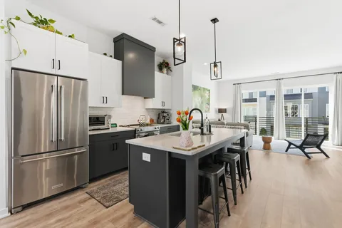 a kitchen with stainless steel appliances granite countertop a sink refrigerator and microwave