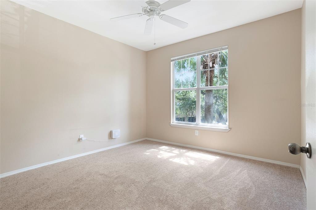 408 Summit Ridge Place, Unit 210 Longwood, FL 32779 - Photo 13 of 32 an empty room with a window and a fan