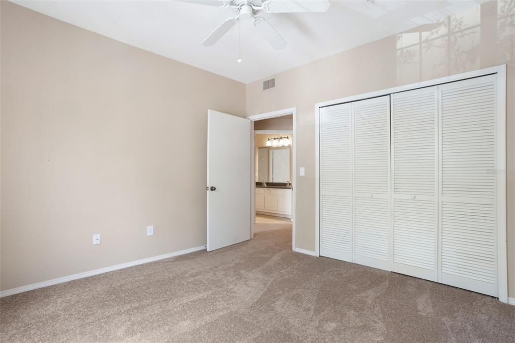 408 Summit Ridge Place, Unit 210 Longwood, FL 32779 - Photo 14 of 32 an empty room with a ceiling fan and a window