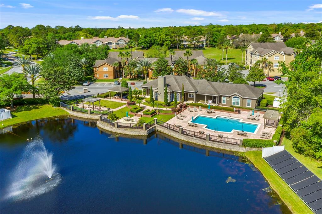 408 Summit Ridge Place, Unit 210 Longwood, FL 32779 - Photo 30 of 32 a view of a swimming pool with a table and chairs